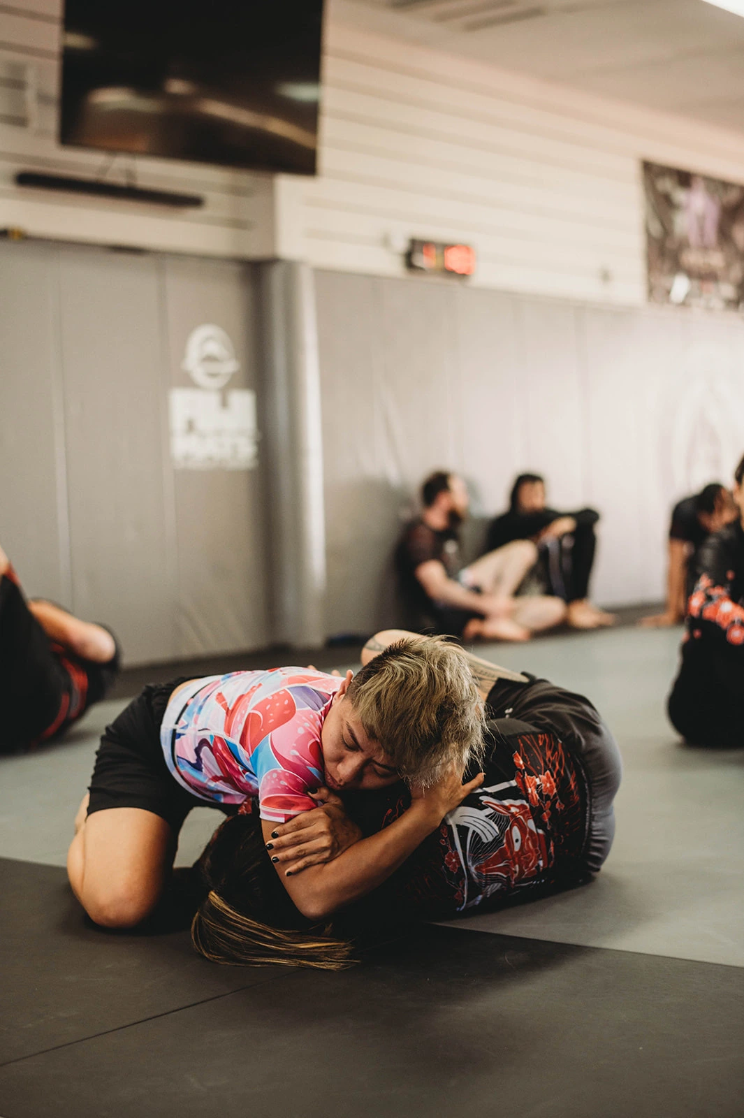 Women grappling in a no-gi BJJ class