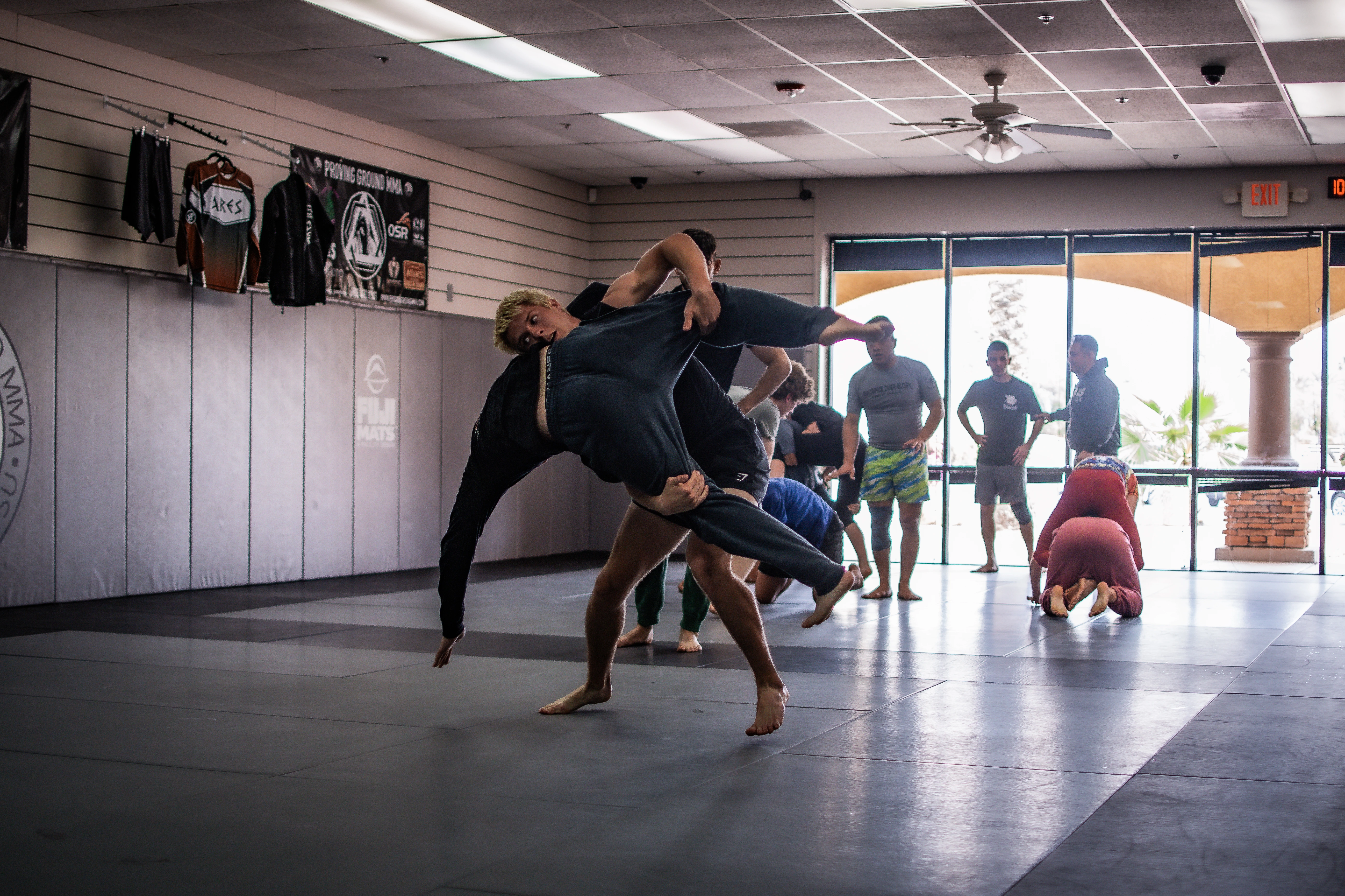 Two adults grappling BJJ at Proving Ground MMA